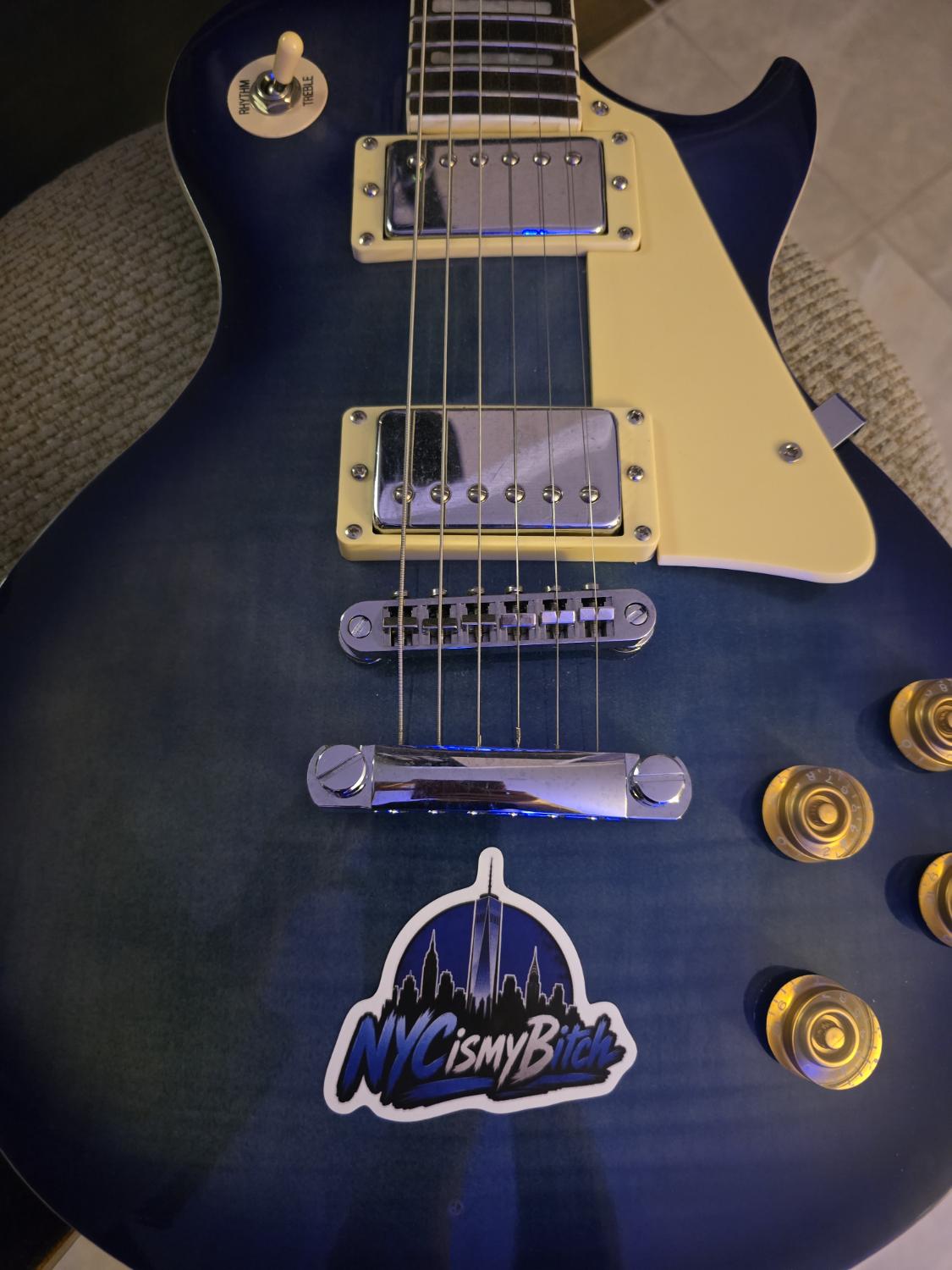 NYC is my Bitch sticker on a blue Les Paul